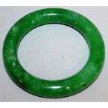 A CHINESE GREEN JADE-LIKE BANGLE, 3.1in diameter.