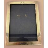 A STERLING SILVER UPRIGHT PHOTOGRAPH FRAME Engraved A. A. 9.25ins high x 6.75ins wide.