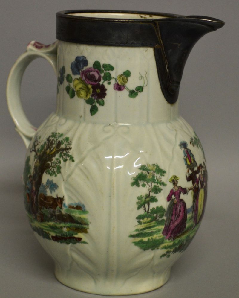 A WORCESTER CABBAGE LEAF JUG painted with rural scenes. 8ins high.