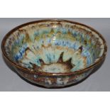 A STONEWARE STUDIO CIRULAR BOWL with splash decorated body.