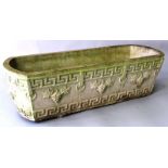 A RECONSTITUTED STONE TROUGH of rounded rectangular form decorated with a Greek key border and
