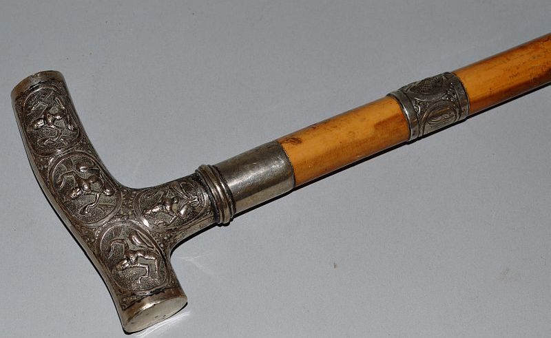 AN INDIAN WALKING STICK with silver handle.  36ins long.