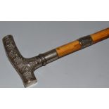 AN INDIAN WALKING STICK with silver handle.  36ins long.