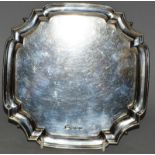 A SQUARE SILVER PIE CRUST SALVER, 7.5ins, supported on three pad feet. Sheffield 1956. Weight 10ozs.