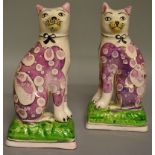 A PAIR OF PINK LUSTRE PEARLWARE SEATED CATS, CIRCA. 1810-1815, with ribbon collars, open legs and