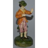 A WHIELDON TYPE POLYCHROME FIGURE OF A STANDING MAN on a circular base. 5ins high.