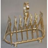A NOVELTY CRICKET TOAST RACK with crossed bats, stumps & balls.