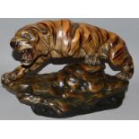 A LARGE FRENCH TERRACOTTA TIGER. Signed T. CARTIER, standing on a rocky base. 22ins long.