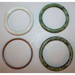 THREE CHINESE JADE-LIKE BANGLES, 3.25in diameter & smaller; together with a paste bangle, 2.9in