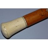 A MALACCA CANE with ivory handle. 35ins long.