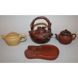 A GROUP OF THREE CHINESE YIXING POTTERY TEAPOTS & COVERS, each with impressed marks to base, two