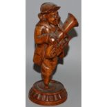 A 19TH CENTURY FRENCH CARVED FRUITWOOD MUSICIAN, a man playing a French horn. 7ins high.