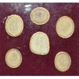 A FRAMED COLLECTION OF SIX PLASTER MEDALLIONS in a mahogany frame.