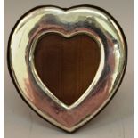 A HEART SHAPED EASEL PHOTOGRAPH FRAME. 6ins high x 5.5ins wide.