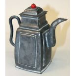 AN EARLY 20TH CENTURY CHINESE PEWTER TEAPOT & COVER, with red glass finial, the base with