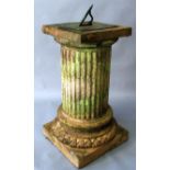 AN ENGRAVED BRASS SUNDIAL supported on a terracotta base of classical column form. 2ft 6ins high.