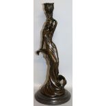 MILO A BRONZE FEMALE CANDLESTICK. Signed. 12ins high, on a circular marble base.