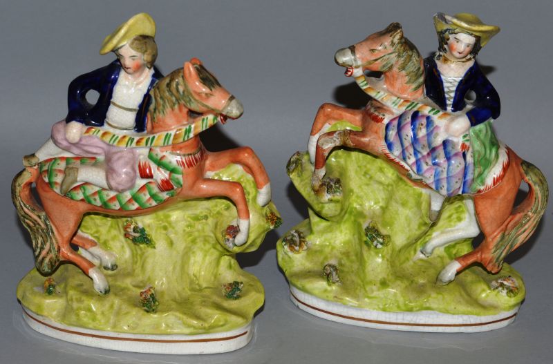 A PAIR OF STAFFORDSHIRE GROUPS, YOUNG LADIES AND GENTLEMEN RIDING PONIES. 7ins high (one AF).