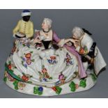 A MEISSEN DESIGN PORCELAIN GROUP OF A GALLANT AND LADY, a pug dog on her lap, a black serving boy.