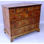 A GEORGE I WALNUT CHEST OF DRAWERS, with quarter veneered top within a herringbone and crossbanded