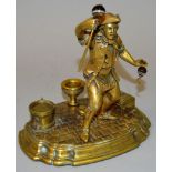A GOOD BRASS TABLE STAND with a man holding onyx stick and hook, box and other objects on the