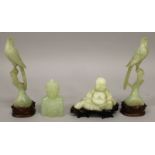 A PAIR OF CHINESE CELADON GREEN BOWENITE BIRDS, with fitted wood stands, each depicted perched on