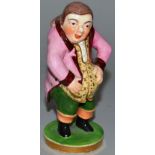 A DERBY PORCELAIN FIGURE SEMI GROTESQUE TOPER in coloured enamels on a circular base. 5ins high. See