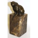 MILO A BRONZE SEATED POLAR BEAR. 3.5ins high, on a marble plinth.