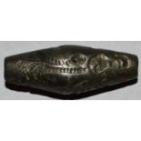 AN UNUSUAL AFGHAN ENGRAVED METAL TOGGLE SHAPED “CYLINDER SEAL”. 1.5ins long.