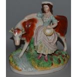 A STAFFORDSHIRE GROUP “THE MILKMAID”. 10ins high.