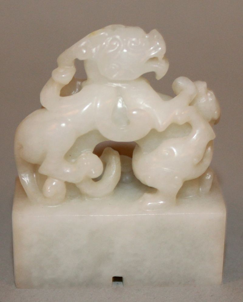 A SMALL CHINESE WHITE JADE-LIKE SEAL, in the form of two battling chilong, the base 1.6in x 0.75in & - Image 2 of 3