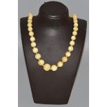 AN IVORY FIFTY BEAD NECKLACE.