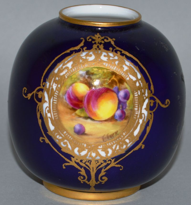 A SMALL ROYAL WORCESTER VASE, Pattern No. 2491, rich blue ground painted with fruit.