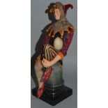 A ROYAL DOULTON FIGURE “THE JESTER”, HN1702. 10.5ins high. Piece missing off hat.