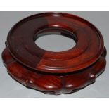 A CHINESE HARDWOOD CIRCULAR STAND. 6ins diameter.