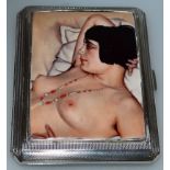 AN ENGINE TURNED CIGARETTE CASE, Birmingham 1922, set with a nude picture.