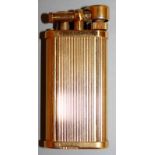 A DUNHILL GOLD COLOURED RIBBED GAS LIGHTER. No. 357331.