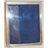 A LARGE .925 UPRIGHT PHOTOGRAPH FRAME with reeded edges. 12ins high x 9.5ins wide.