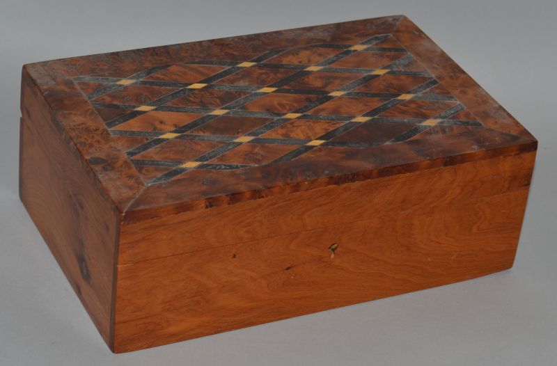 A YEW WOOD JEWELLERY BOX with inlaid lid and fitted interior. 9.5ins wide.
