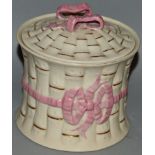 A BELLEEK CIRCULAR TOBACCO BOX AND COVER with pink ribbons. Black mark. 4ins high.