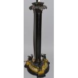 A VERY GOOD REGENCY BRONZE TABLE LAMP, the shaped base with three winged lions. 24ins high.