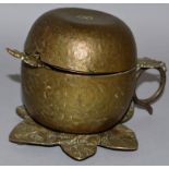 A GILDED APPLE JAM POT AND COVER with spoon on a leaf base. 4.5ins high.