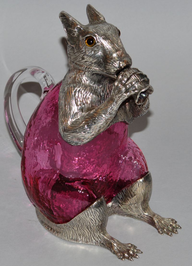 A GOOD SQUIRREL RUBY GLASS CLARET JUG with plated head, glass eyes and feet. 7ins high.