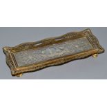 A FRENCH FILIGREE PEN TRAY with filigree silver panel in glass, a man and dog. 8.5ins long.