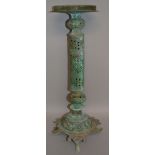 AN ISLAMIC BRONZE LAMP STAND with galleried circular top, pierced column support on a shaped