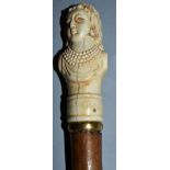 A CANE with carved European ivory handle, bust of a lady with four rows of pearls. 36ins long.