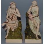 A PAIR OF ROYAL DUX PORCELAIN FIGURES OF TWO CLASSICAL WOMEN, both seated, one carrying a bow, the