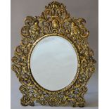 A GOOD 19TH CENTURY PIERCED BRASS EASEL MIRROR with bevelled mirrored panel. 21ins high.