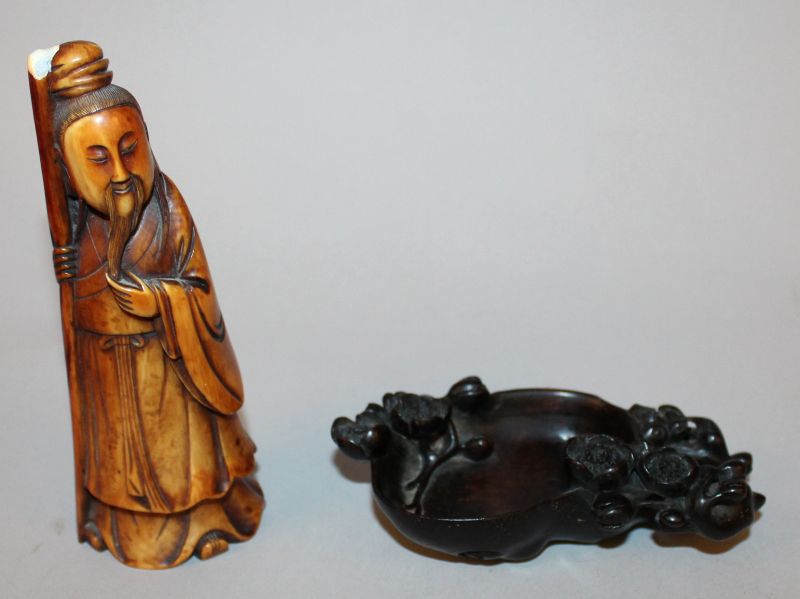 A CHINESE STAINED IVORY FIGURE OF A SAGE, 5.3in high; together with a wood brushwasher, 4.5in
