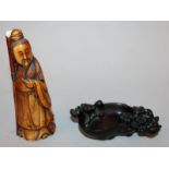 A CHINESE STAINED IVORY FIGURE OF A SAGE, 5.3in high; together with a wood brushwasher, 4.5in